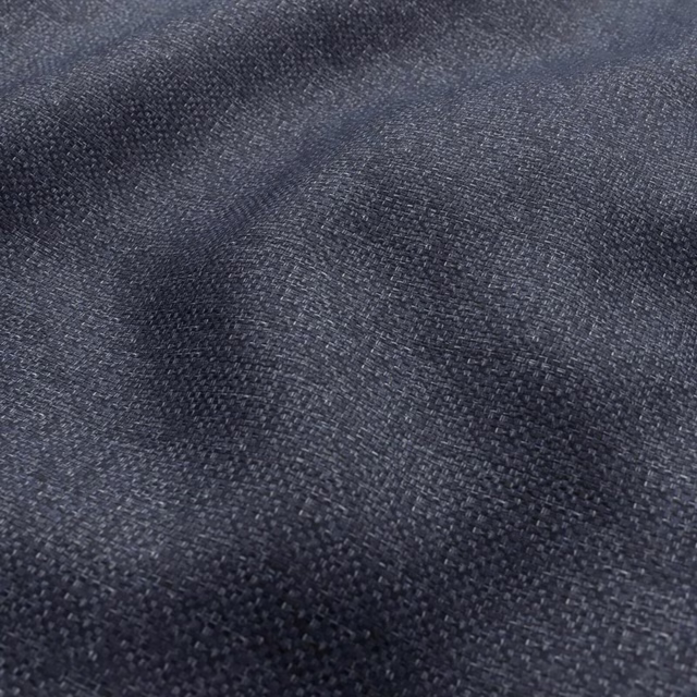 Close-up of dark slate blue-grey woven fabric with mottled charcoal texture
