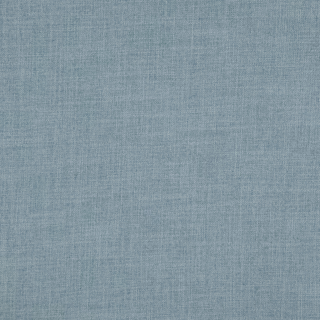Muted blue-grey close-up showing a fine woven surface with delicate tonal flecks