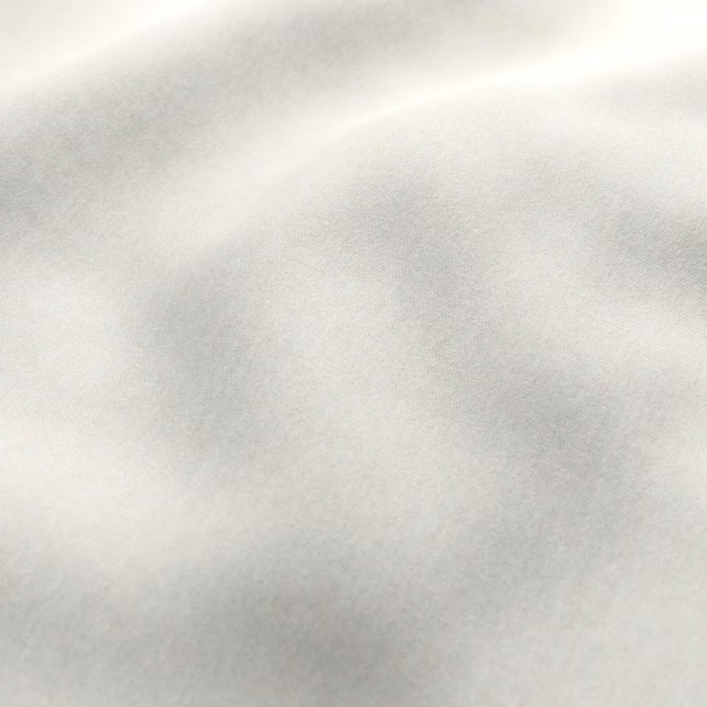 Pale porcelain cream fabric with a soft, cloudy tonal woven surface