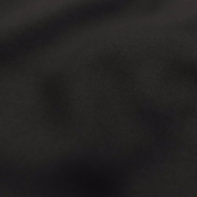 Deep black Bute textile showing a fine weave and subtle mottled surface sheen