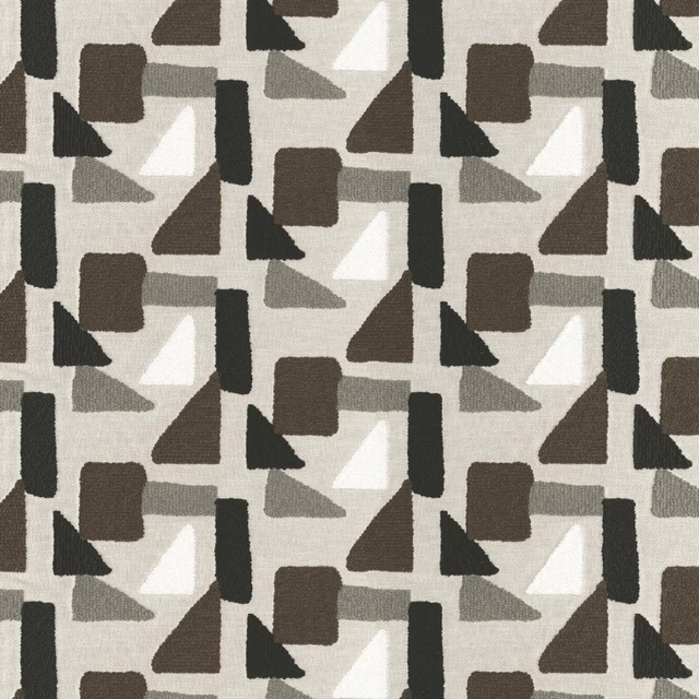 Warm calico geometric fabric with charcoal, brown, grey and white abstract shapes