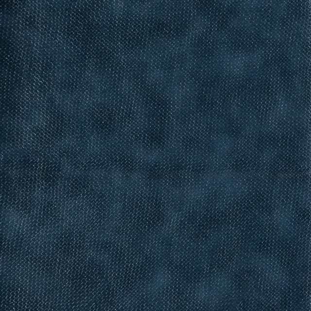 Close-up of dark indigo fabric with fine woven texture and softly mottled blue shading