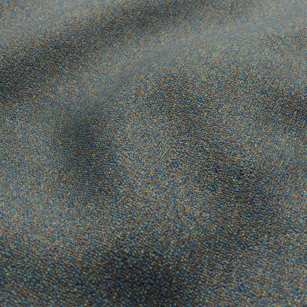 Close-up of muted blue-grey woven textile with taupe flecks and softly mottled shading.