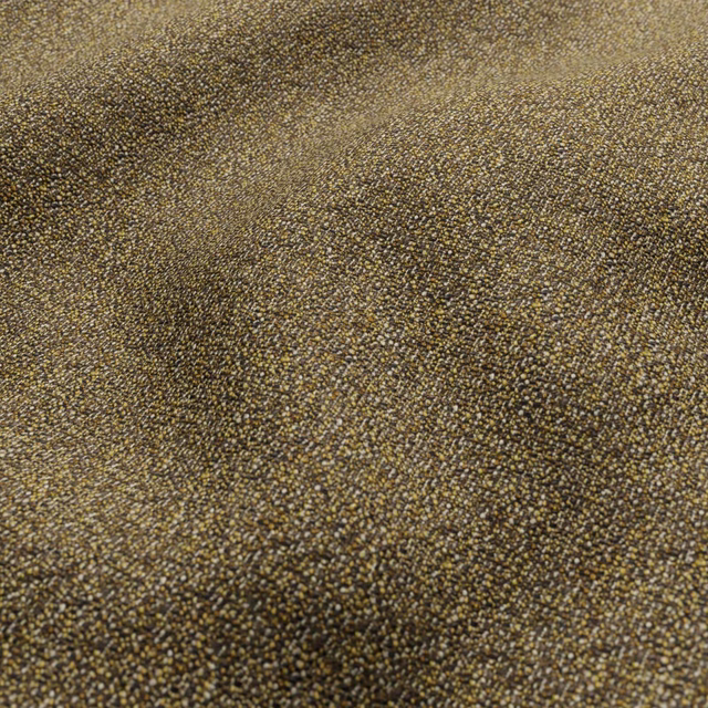 Close-up of olive-brown woven textile with tiny golden flecks and pebbled texture