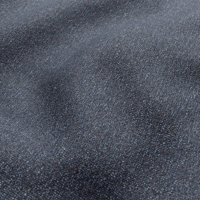 Close-up of deep blue-grey Jean fabric with a fine mottled woven texture