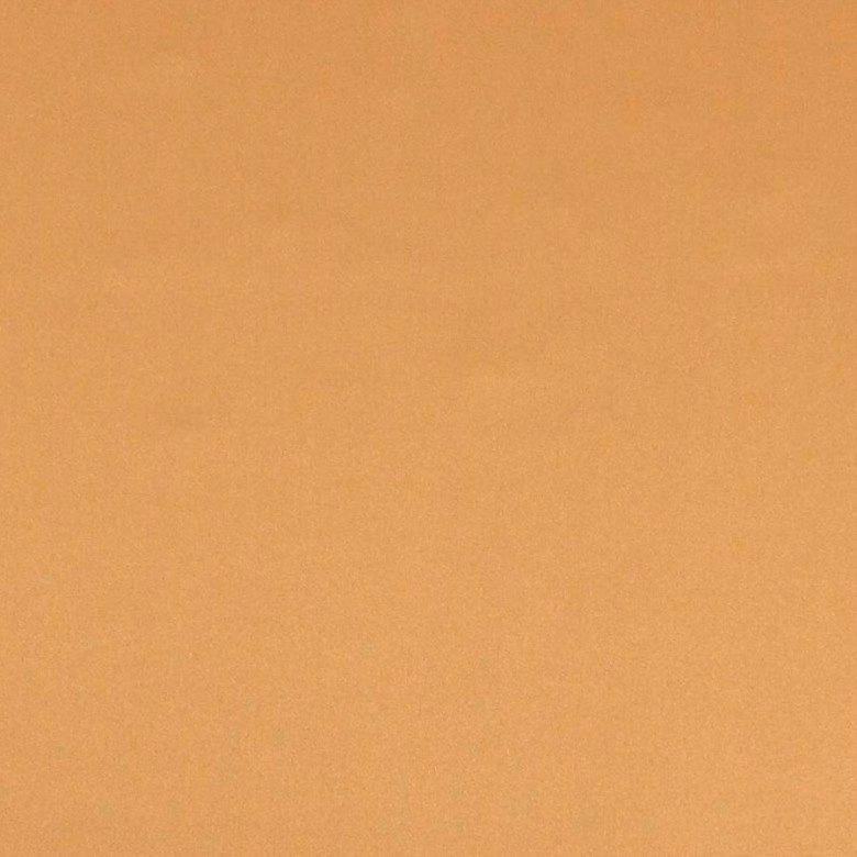 Plain muted ginger-orange fabric showing a softly mottled fine-grain surface
