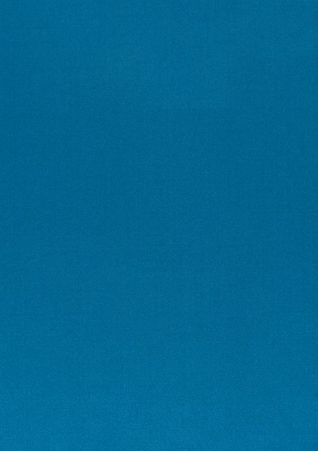 Saturated teal-blue fabric showing a fine, subtly grainy plain weave