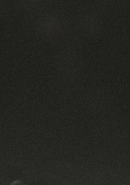 Near-black charcoal fabric with a quiet matte weave and faint surface variation