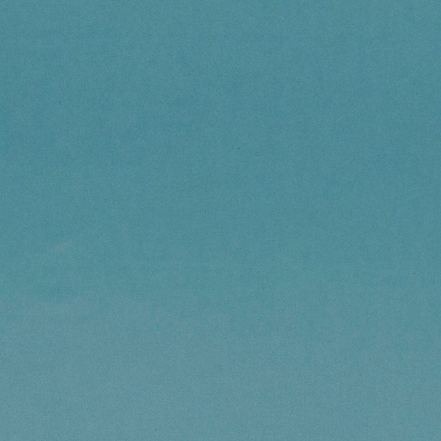 Muted blue-teal plain fabric swatch with a fine softly mottled texture