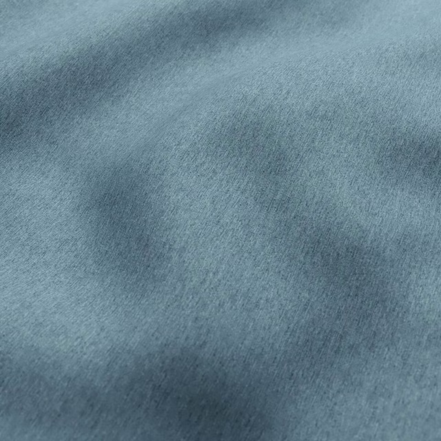 Close view of muted blue-grey fabric with soft brushed nap and subtle tonal variation
