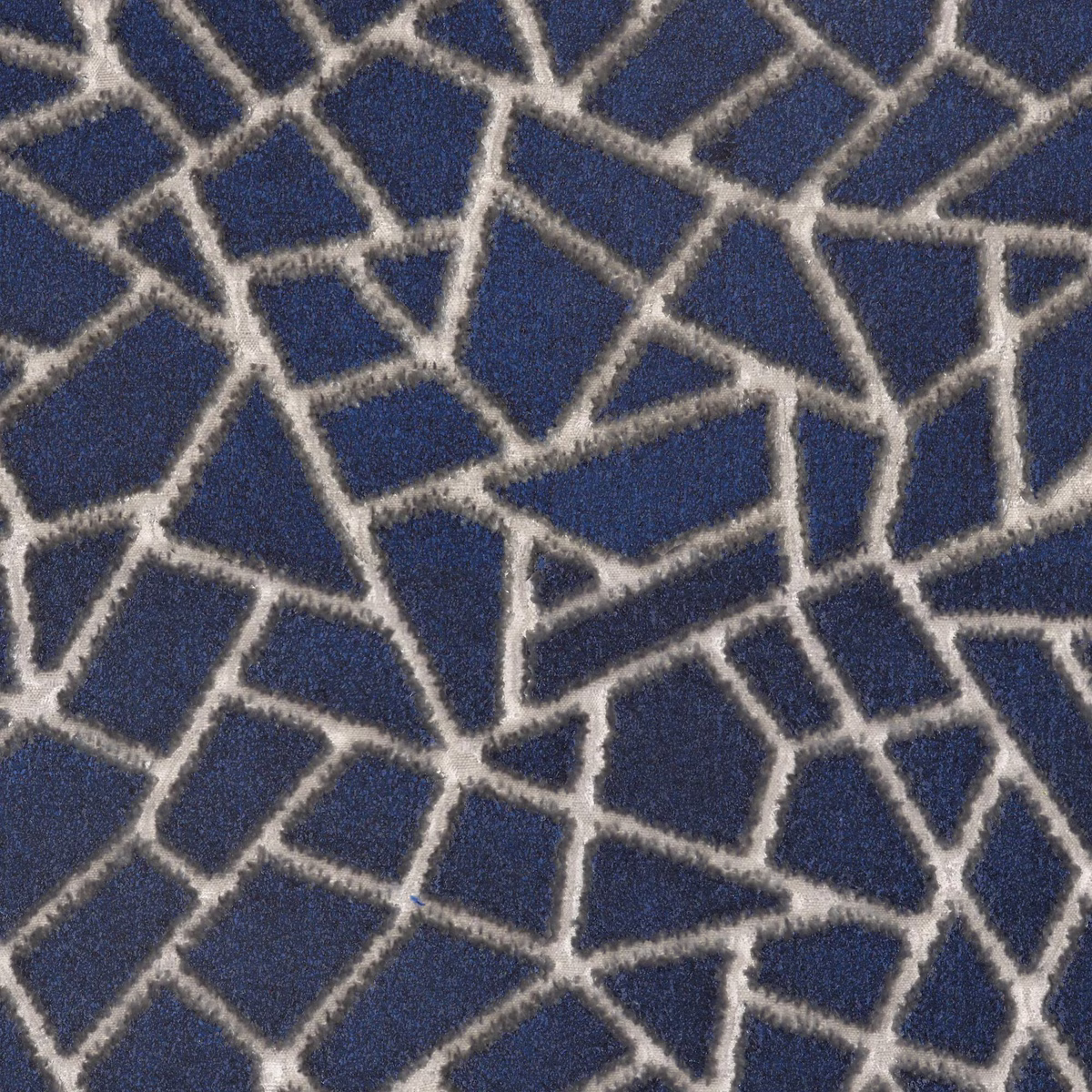 Ink-blue textured fabric with irregular cream lines forming fractured geometric cells