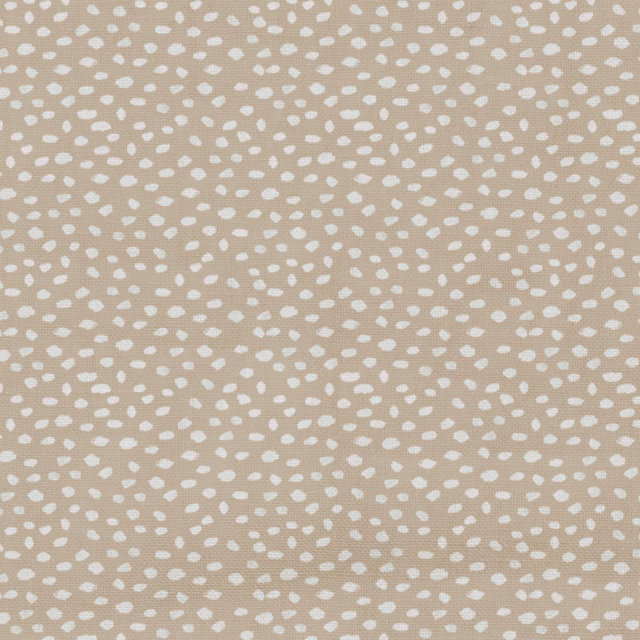 Warm nougat taupe fabric with scattered off-white pebble-like dots and subtle woven texture