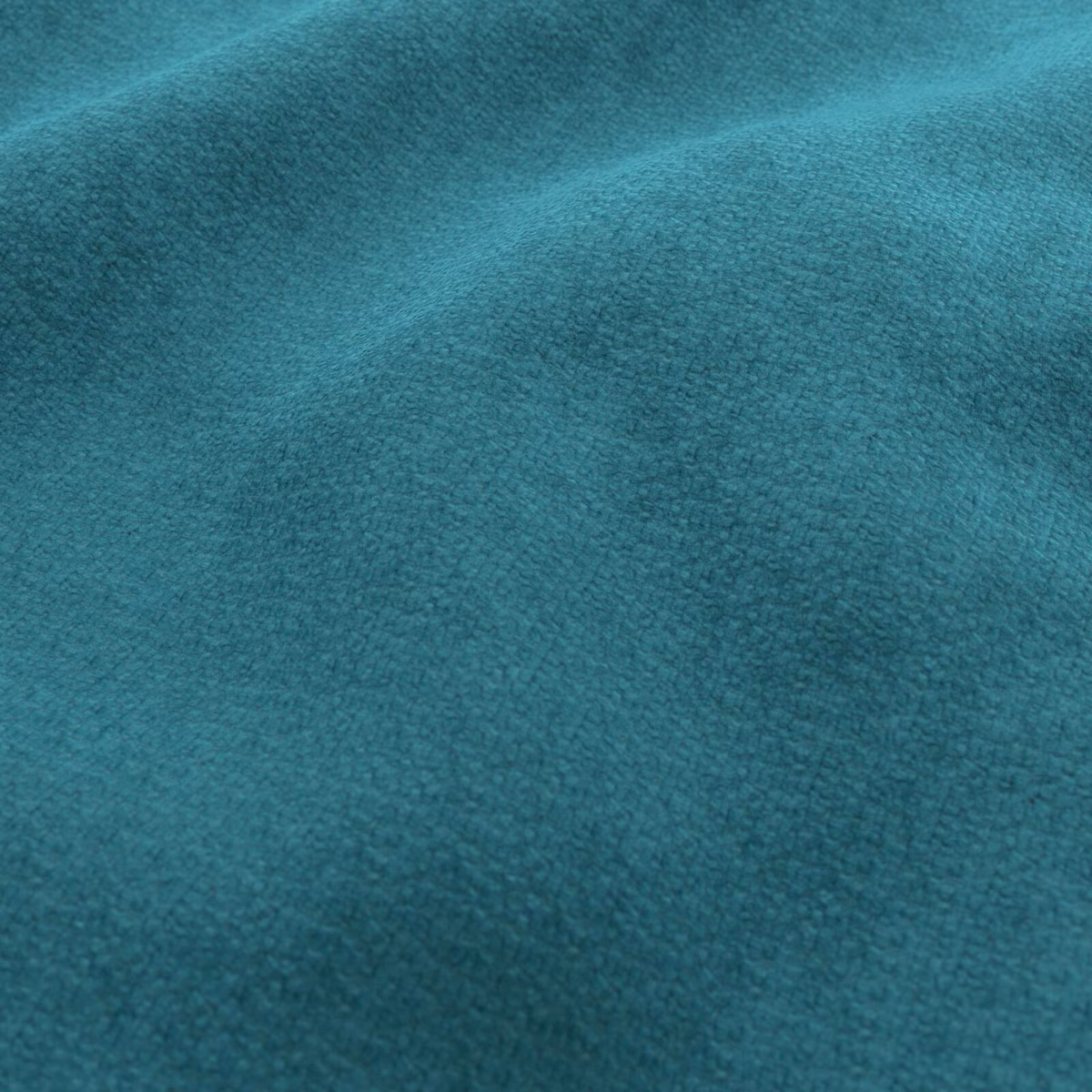 Close view of deep teal plush pile with subtle turquoise light shifts