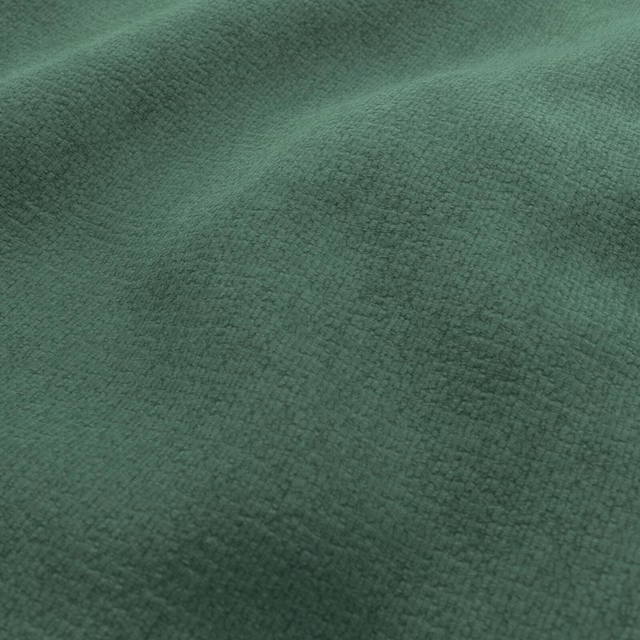 Close view of emerald-green fabric with a fine, softly pebbled woven texture