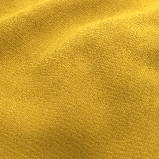 Close-up of warm golden-yellow woven fabric with a softly nubby, grainy texture