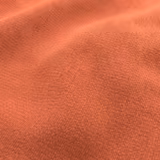 Warm dark coral textile with a dense, finely pebbled woven texture