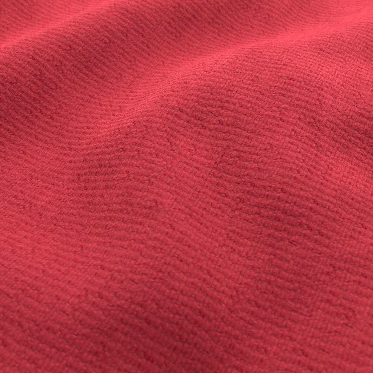 Close-up of saturated fuchsia fabric with fine irregular ridges and darker folds