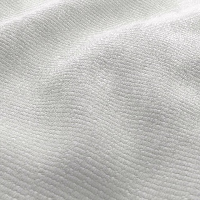 Near-white cream fabric with fine curved ribs and softly shaded woven texture
