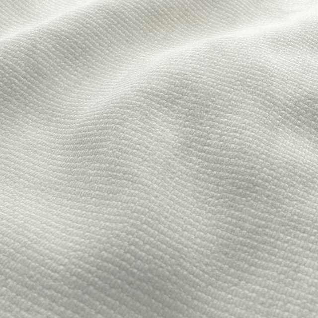 Close-up of ivory off-white fabric with fine horizontal ridges and soft folds