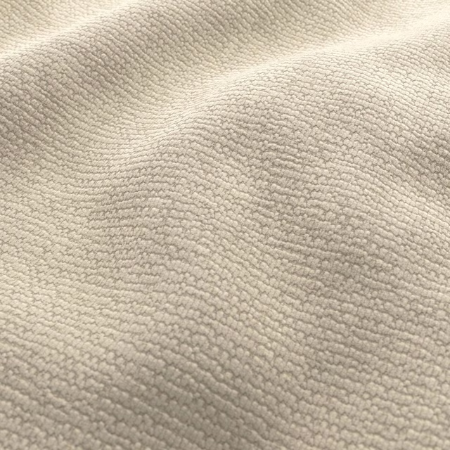 Close-up of warm dune-beige looped texture with softly rippled tonal shading