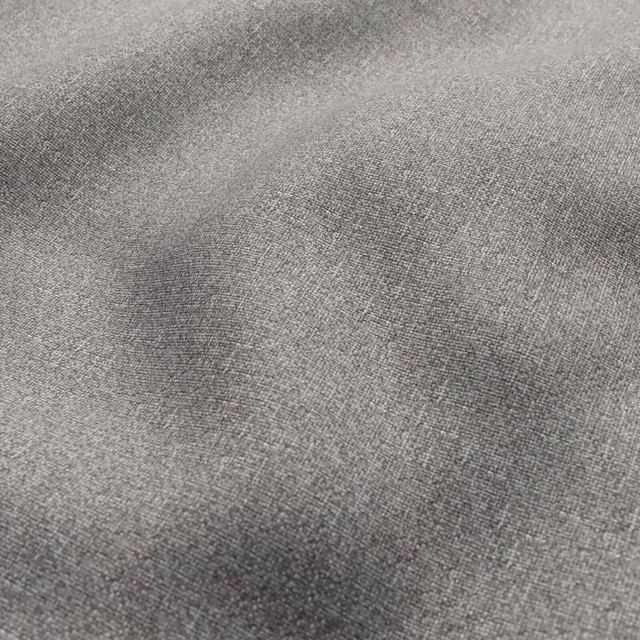 Close-up of mottled gravel-grey woven fabric with fine charcoal and silver tonal variation
