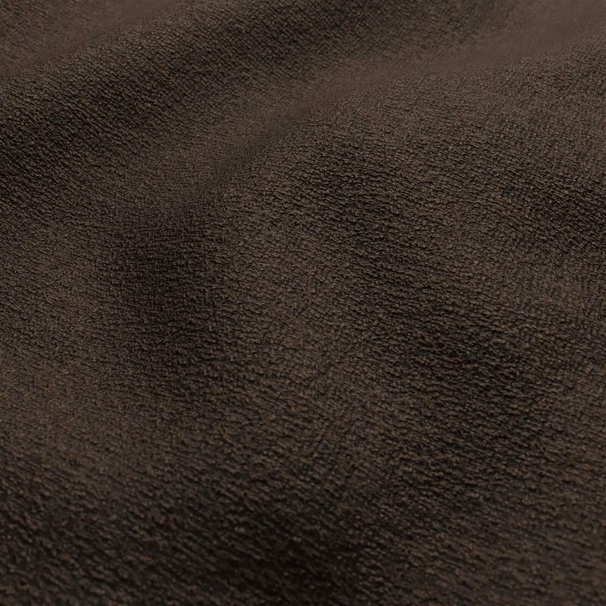 Close-up of dark truffle-brown fabric with dense rippled texture and soft directional sheen