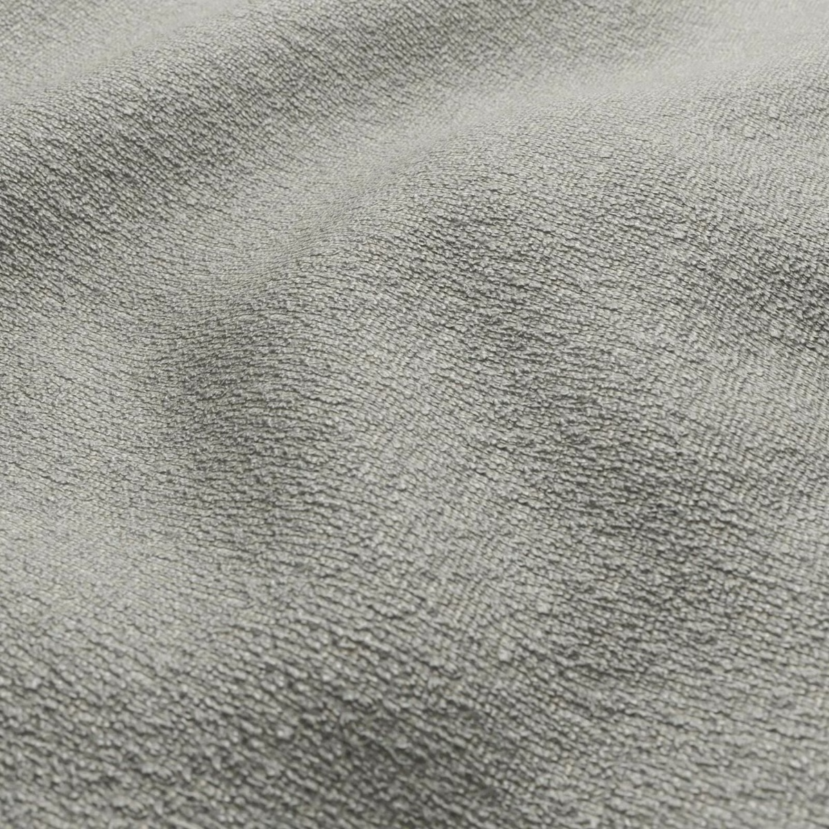 Close-up of muted seafoam grey-green fabric with a fuzzy, mottled woven texture