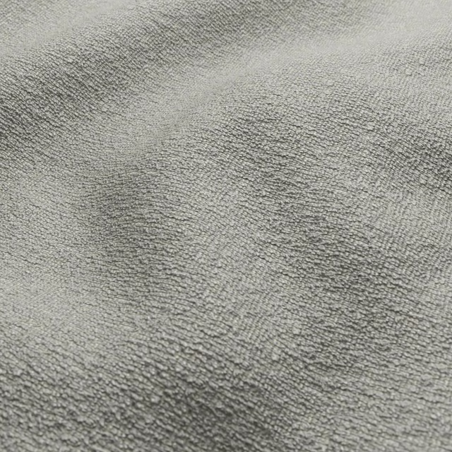 Close-up of muted seafoam grey-green fabric with a fuzzy, mottled woven texture