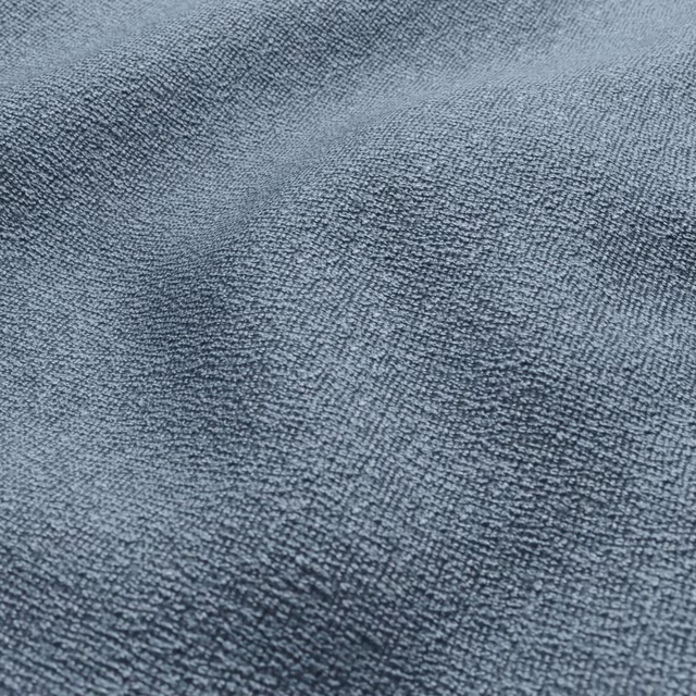 Close-up of muted powder-blue fabric with dense, softly nubby woven texture