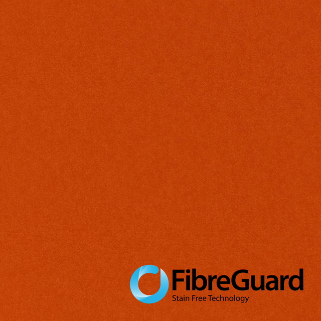 Close-up of saturated paprika-orange plain fabric with a softly mottled, even surface