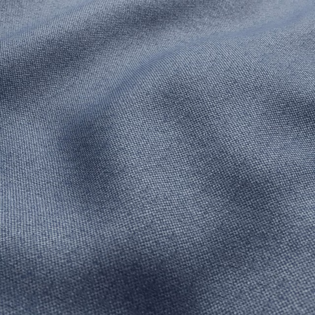 Close-up of muted blue-grey woven fabric with softly mottled slate texture
