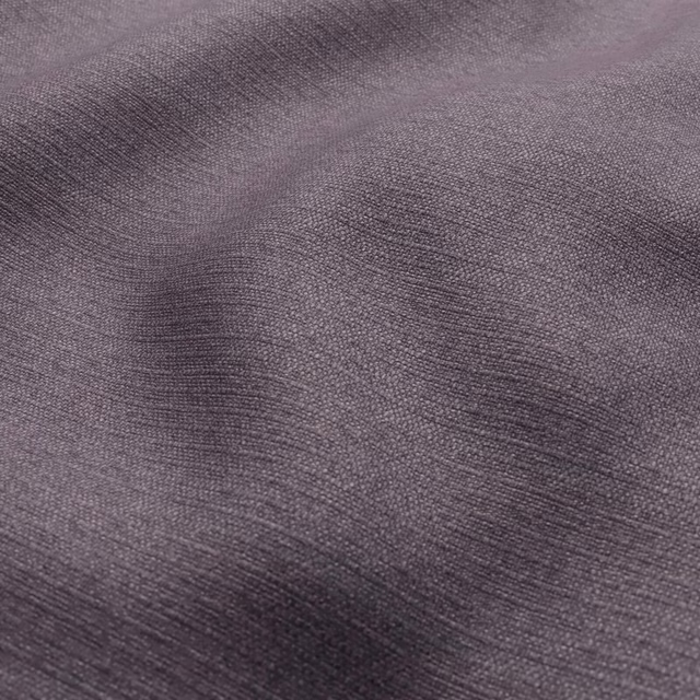 Close-up of cool grey-lavender fabric with a fine, softly rippled woven texture