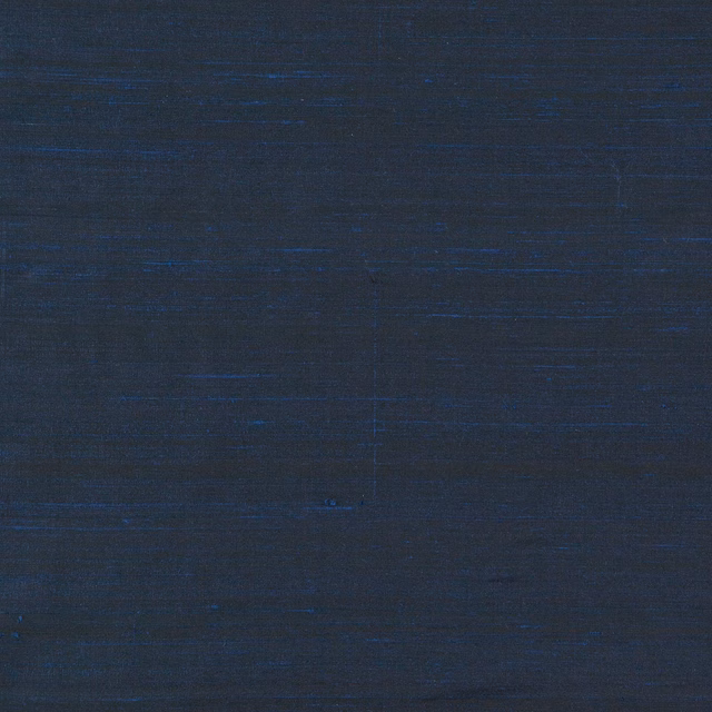 Deep indigo textile with fine horizontal slubs and subtle crosshatched texture