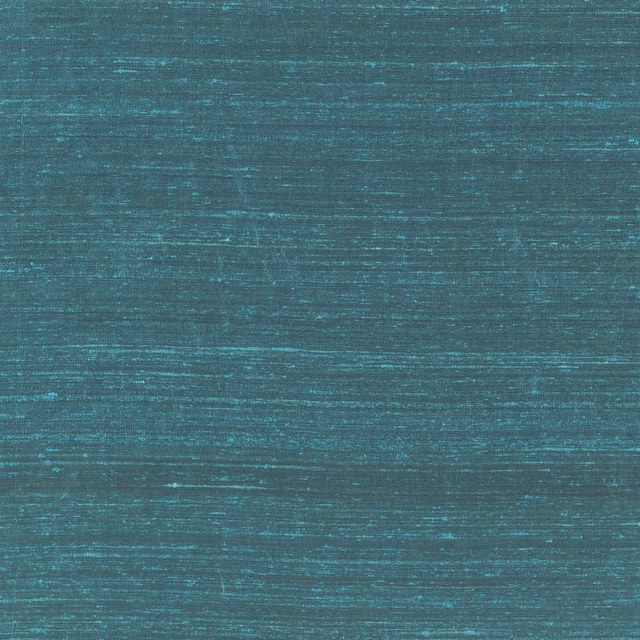 Close-up of cobalt teal fabric with fine horizontal striations and slub texture