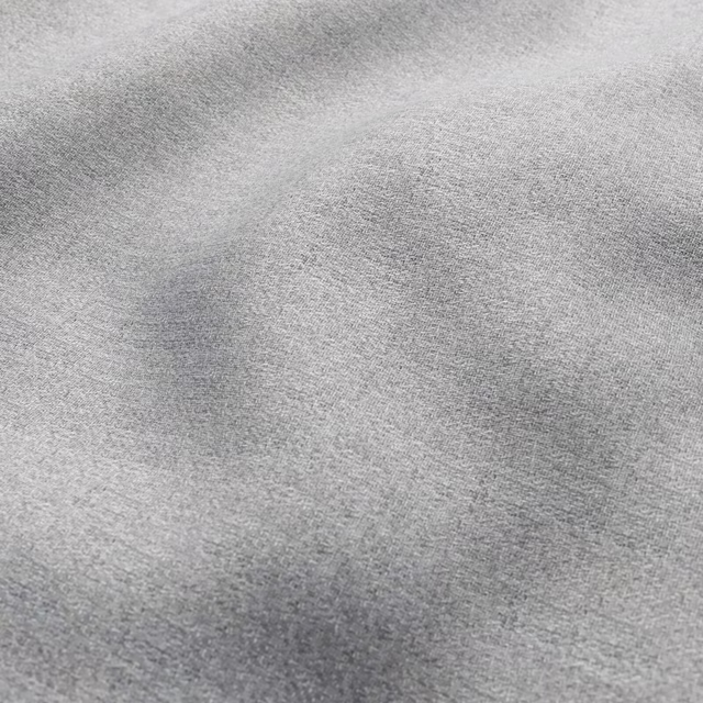 Close view of cool mist grey fabric with fine mottled woven texture