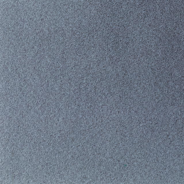 Close-up of cool blue-grey fabric with a dense, finely mottled texture