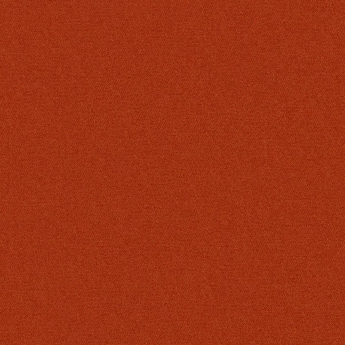 Close-up of warm clay-red fabric with a fine, subtly mottled woven texture