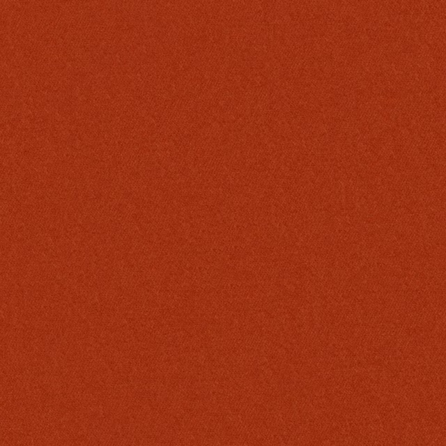 Close-up of warm clay-red fabric with a fine, subtly mottled woven texture