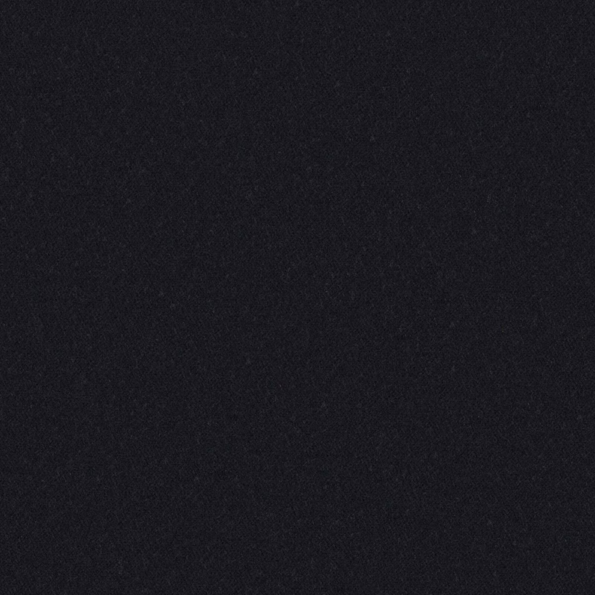 Close-up of near-black carbon fabric with a softly mottled, fibrous surface
