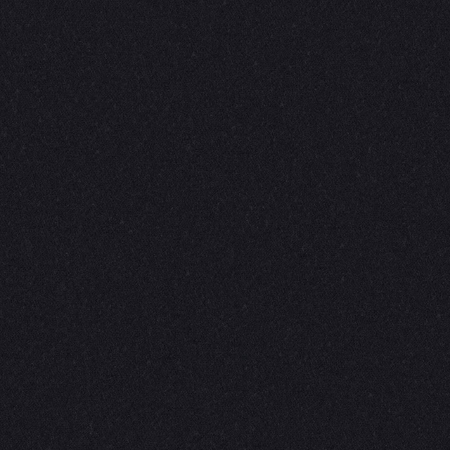Close-up of near-black carbon fabric with a softly mottled, fibrous surface