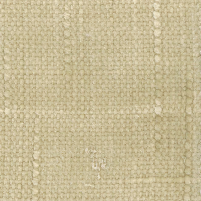 Close-up of pale limestone fabric showing chunky loops and subtle vertical tonal variation