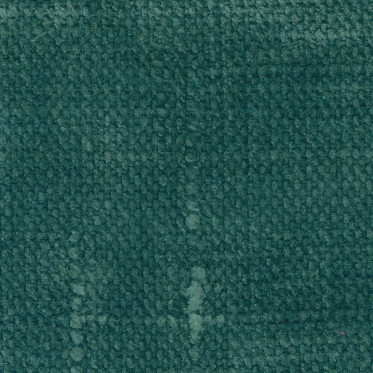 Close-up of deep peacock teal fabric with dense nubby looped texture and tonal flecks