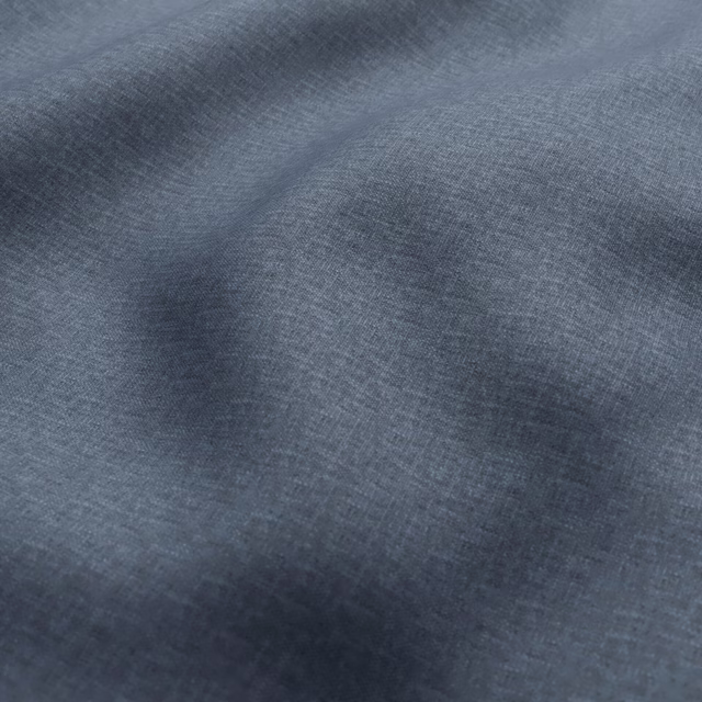Close-up of cool slate-blue woven fabric with fine crosshatch texture and tonal shading