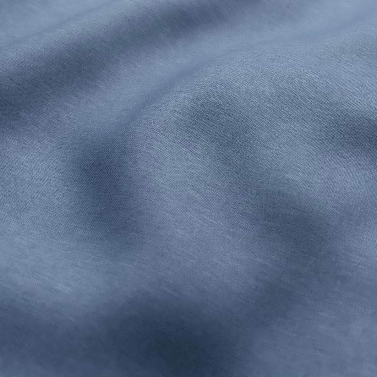 Mottled mineral blue textile with smoky tonal bands and fine woven grain