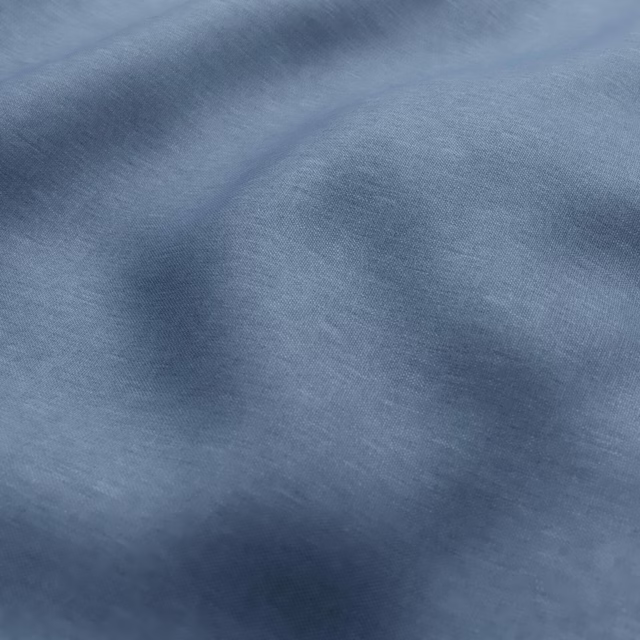 Mottled mineral blue textile with smoky tonal bands and fine woven grain