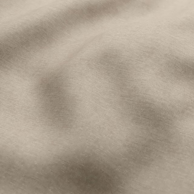 Warm taupe fabric with softly mottled shading and a fine woven texture