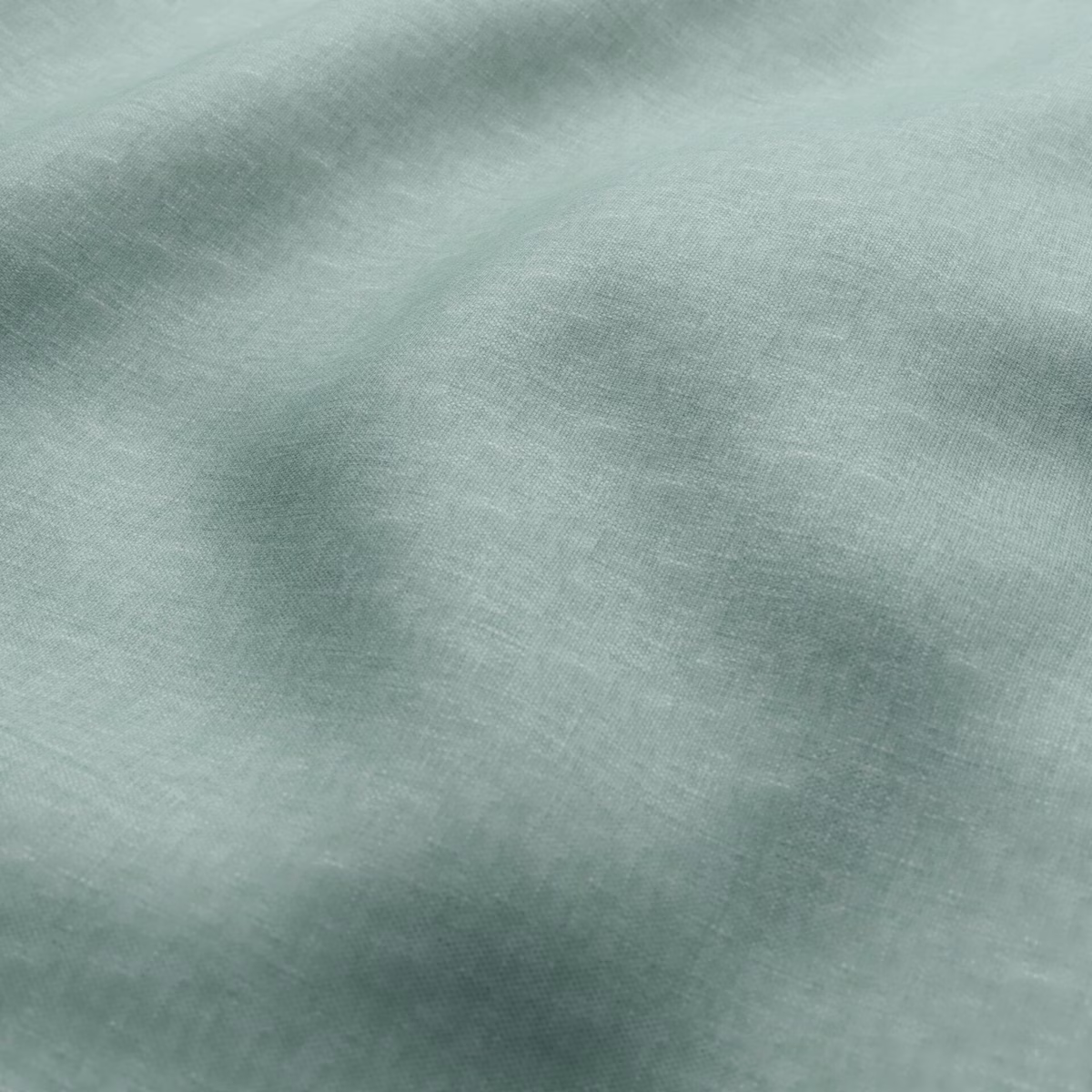 Pale sage-green fabric with cloudy tonal shading over a fine woven surface