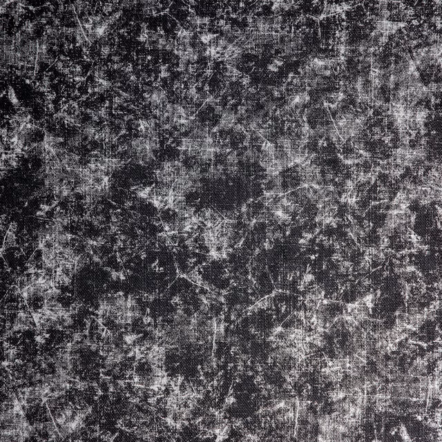 Charcoal-black textile with pale grey distressed marks and crosshatched woven texture