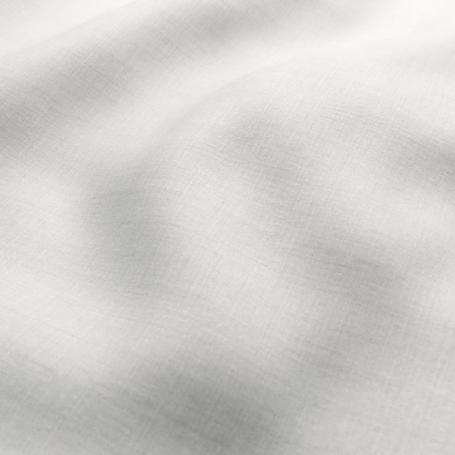 Pale ivory cream fabric with a fine crosshatched weave and softly folded surface