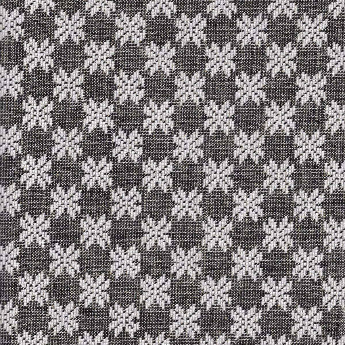 Charcoal woven fabric with repeating ivory eight-point stars in a compact geometric pattern